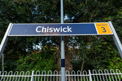 Chiswick station sign with fare zone detail on platform, looking up.
