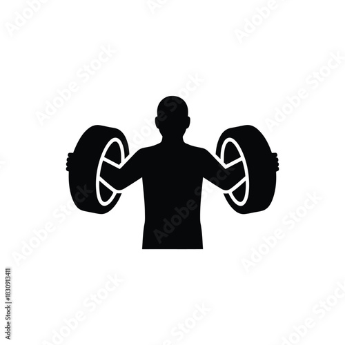 Strong man lifting car tires as weights in a silhouette