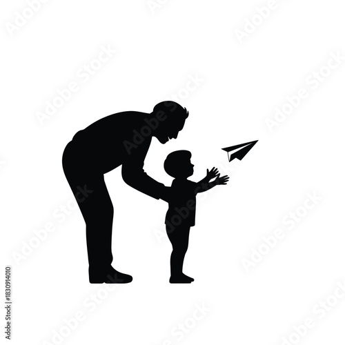 Father and son silhouette playing with paper airplane together outdoors