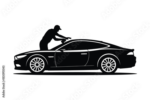 Silhouette of man polishing a sleek sports car with care
