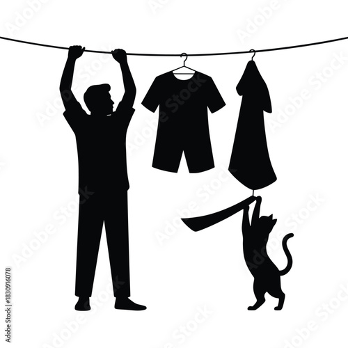 Silhouette of a man hanging laundry with a playful cat