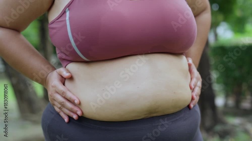 Plus size woman body positive self love exercising healthy living outdoor workout confidence strength, natural light park scene with activewear, confident curves, sweaty abdomen, joyful energy