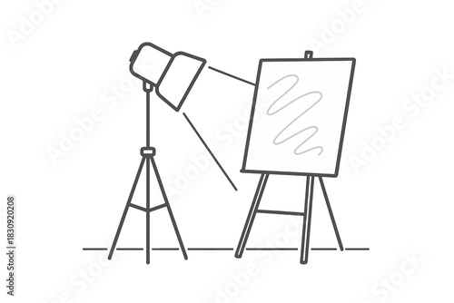 Studio spotlight illuminating a blank canvas on an easel for art production