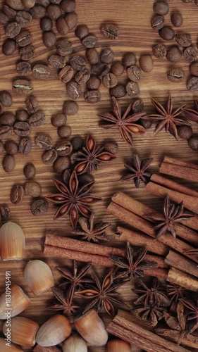 Rotating Cinnamon Sticks, Star Anise and Coffee Beans on Wooden Table Vertical Video