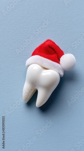 Wallpaper Mural Festive tooth decoration with Santa hat placed on a light blue background during the holiday season Torontodigital.ca