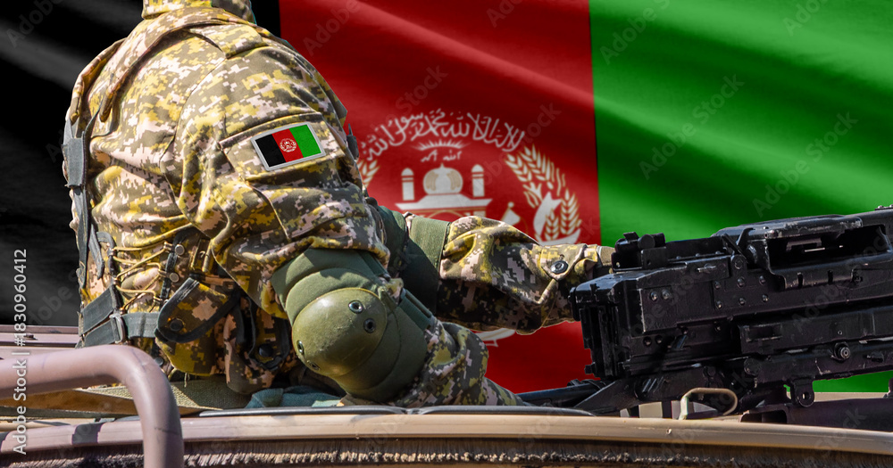 Fototapeta premium Afghanistan flag with soldier at machine gun turret in front of it. Closeup side view.