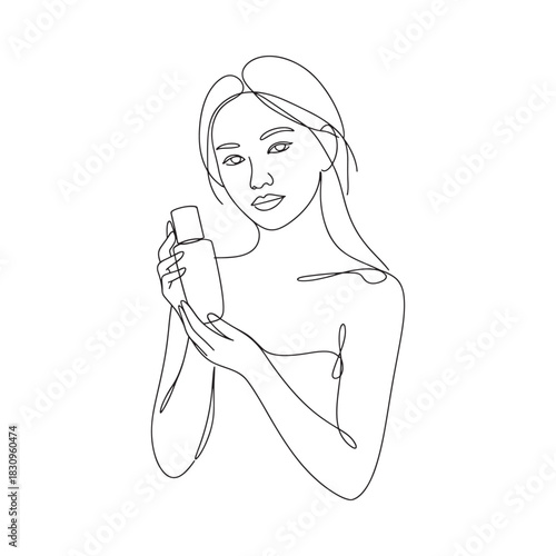 Young woman applying skincare product to her face