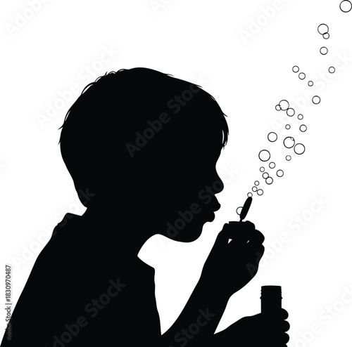 silhouette of a child blowing bubbles into the air