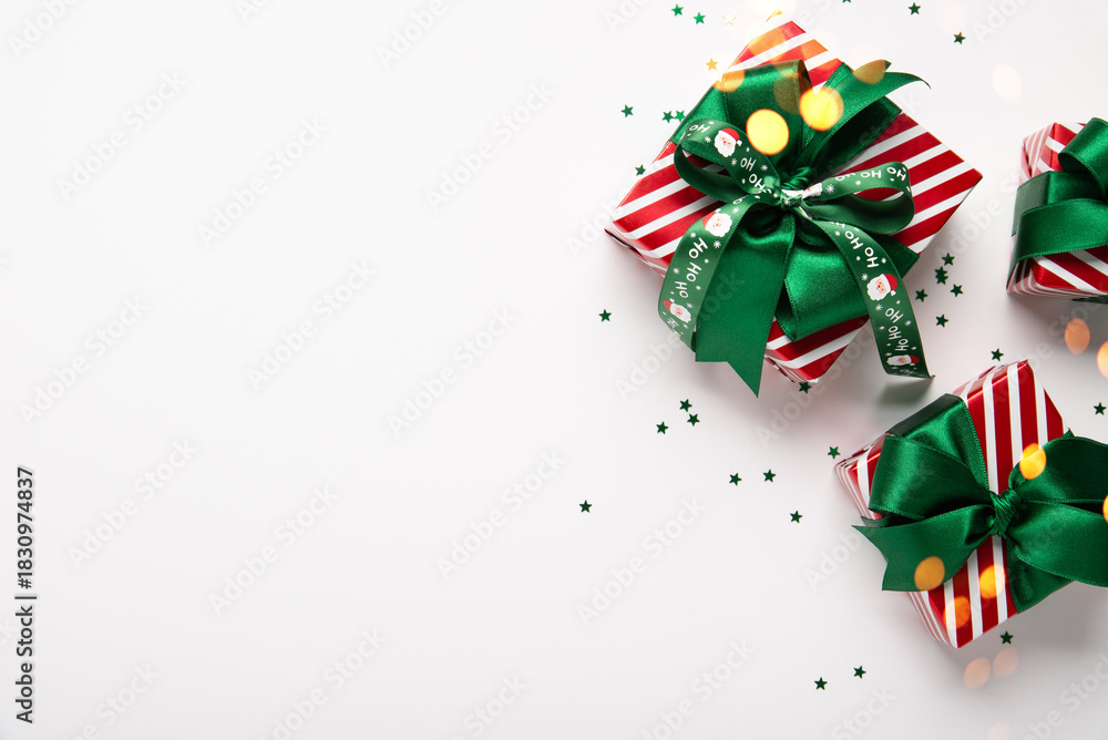 Obraz premium Merry Christmas and Happy Holidays greeting card, frame, border, banner. New Year. Red green Christmas decoration, ornaments and gifts, presents on white background. Xmas holiday festive theme.