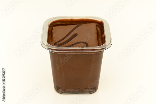 Pieces of swiss roll and knife on cutting board on wooden table