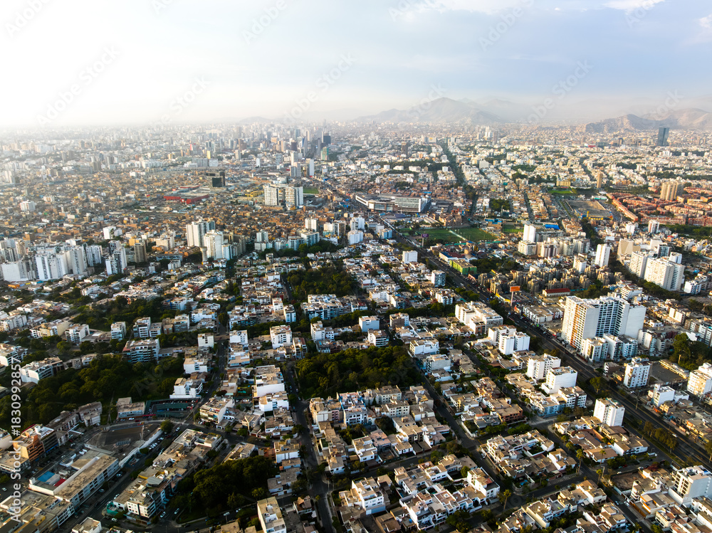 Obraz premium Aerial view of the affluent La Aurora neighborhood in Miraflores, Lima, displaying green parks, organized streets, and modern residential infrastructure.