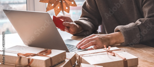 Online Christmas shopping with credit card and laptop, gift boxes and candy cane mug on desk — holiday sale and discounts, e-commerce banner with copy space for promo, Cyber Monday and Black Friday