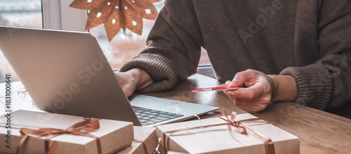 Online Christmas shopping with credit card and laptop, gift boxes and candy cane mug on desk — holiday sale and discounts, e-commerce banner with copy space for promo, Cyber Monday and Black Friday