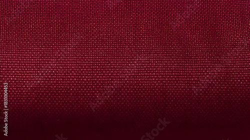 Detailed close up of a burgundy fabric texture,  showcasing the intricate weave and rich color,  perfect for backgrounds and design elements