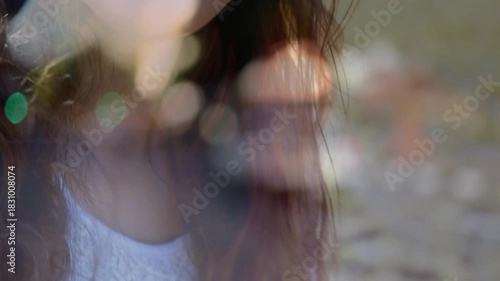 Student holding acoustic guitar, camera pulling back revealing grin, bokeh lifting music mood