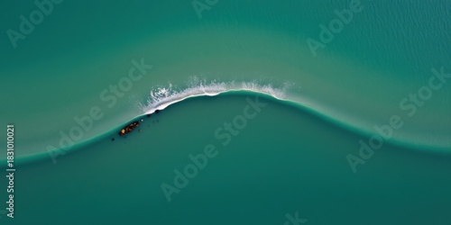 Fototapeta Naklejka Na Ścianę i Meble -  Aerial drone view of a turquoise ocean wave breaking with white foam and a dark shape below
