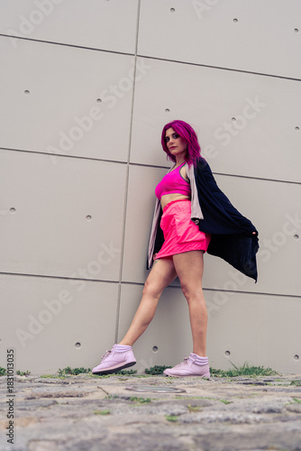 Woman with pink hair posing with urban sportswear