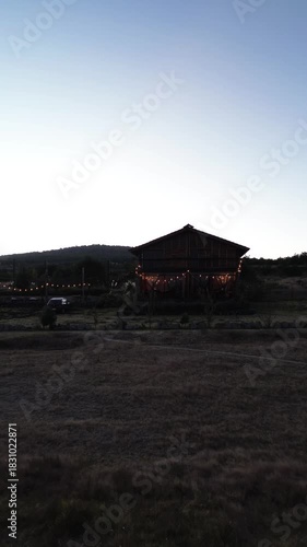 Silhouette of a house at dusk with decorative lights in Mexico dolly out camera movement