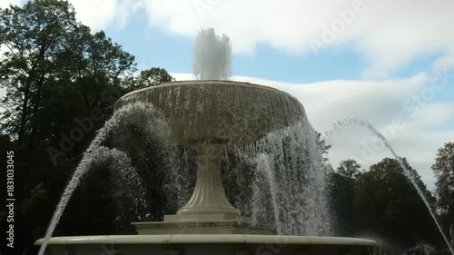 a fountain against a sky with clouds