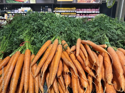 Fresh organic carrots displayed in a grocery store aisle food shopping carrots organic fresh produce vegetables