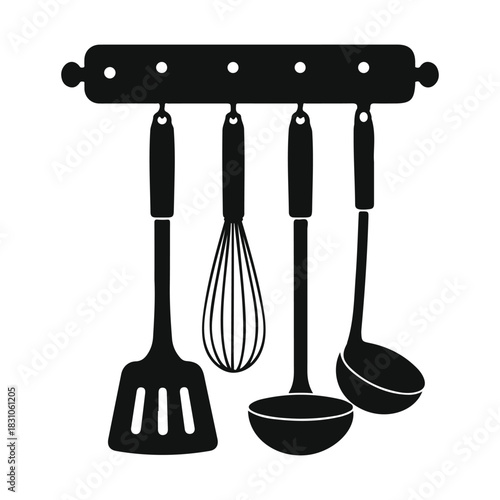 Kitchen utensil set hanging on wall rack, spatula, whisk, ladle, soup spoon