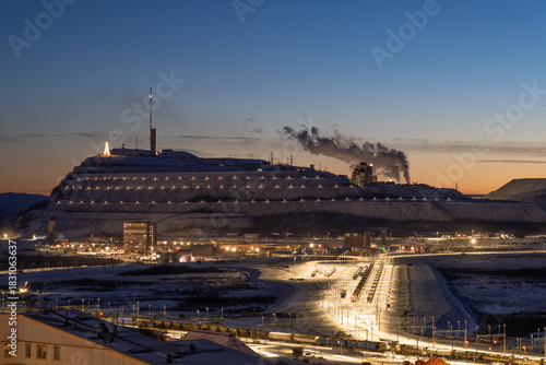 Fotografie Iron ore mine, Kiruna, Sweden, during polar night in winter, with trains waiting