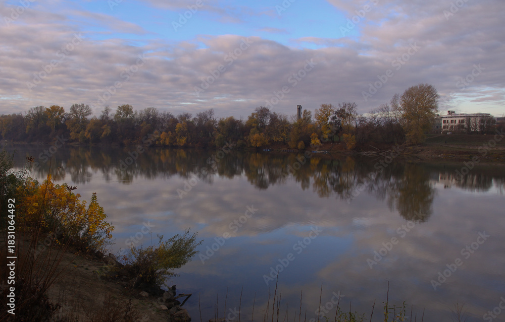 Fototapeta premium Trees in autumn colors reflected in the water