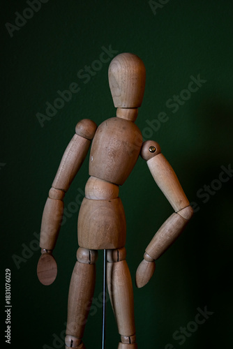 wooden mannequin on a green bacground
