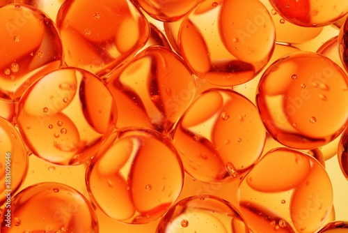 Close-up of translucent orange spheres immersed in liquid with visible air bubbles, designed for cosmetic science visuals, skincare ads, and clean abstract backgrounds