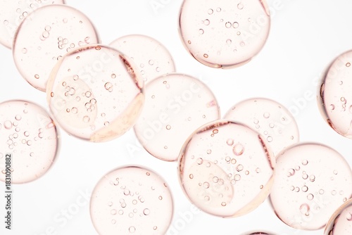 Rose-colored serum droplets with delicate air bubbles in macro view, perfect for skincare advertising, cosmetic branding, and elegant clean visual storytelling