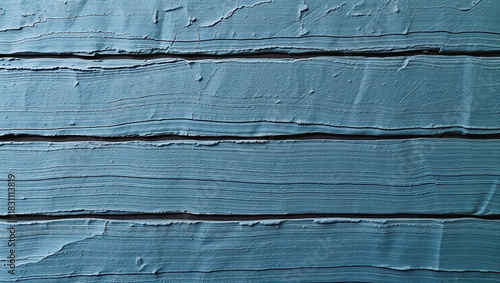 Textured blue paint on wooden surface