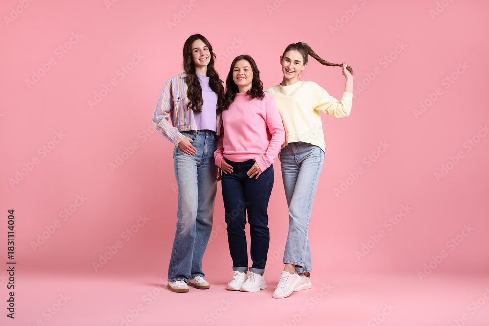 Fototapeta premium Portrait of happy friends on pink background