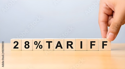 28 Percent Tariff Concept with Wooden Blocks and Hand – Import Tax, Customs Duty, Trade Policy, Price Increase and Protectionism on Neutral Background
