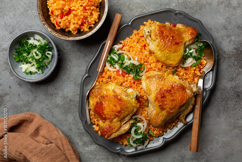 Turkish, Lebanese Bulgur wheat Pilaf with vehetables and roasted chicken, onion and parsley. Top view.