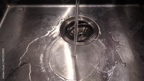 Stockholm, Sweden A water faucet runs into a domestic kitchen sink. 