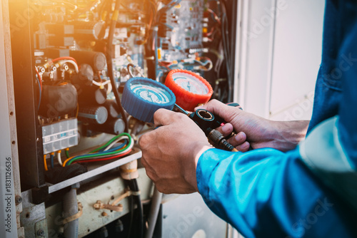 Technician is checking air conditioner refrigerant leak.