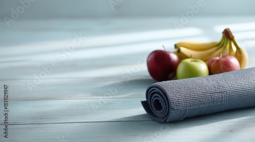 Fototapeta Naklejka Na Ścianę i Meble -  Healthy lifestyle concept with fresh fruits and yoga mat on wooden floor, high-resolution