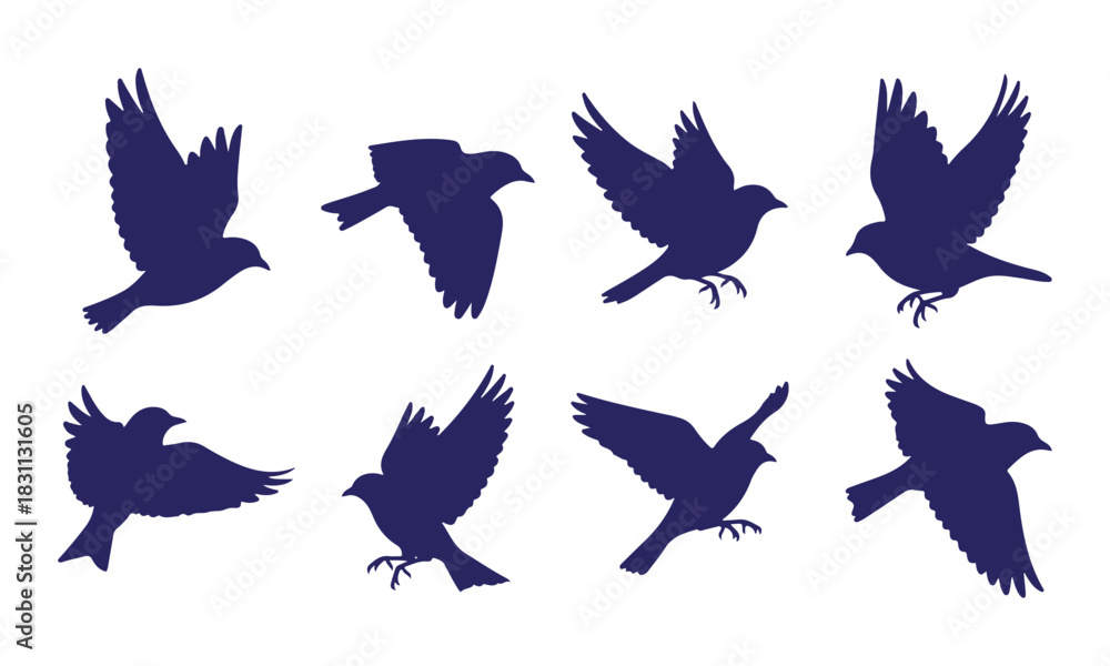 Naklejka premium Set of eight dark blue bird silhouettes in various flying poses isolated on