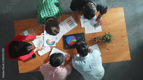Top down aerial view of business team prepare for meeting and brainstorm marketing idea while planning strategy and looking at investment report or financial graph from tablet. Creative. Convocation.