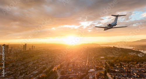Sunset Private Jet Over Burnaby And Vancouver Bay: Modern Airplane At Dusk