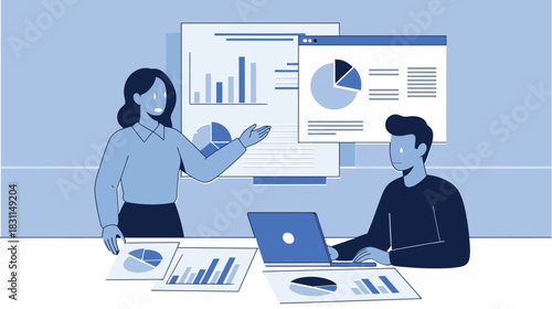 Two business individuals reviewing charts and data, with a woman presenting information and a man working on a laptop in a corporate environment