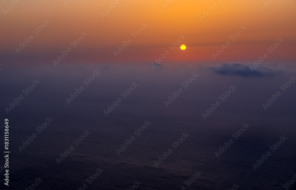 Fototapeta premium Sunset landscape over the Atlantic Ocean. Sunset and sunrise time, nature background and empty area for text, feeling love or romantic background in nature, sky background with clouds