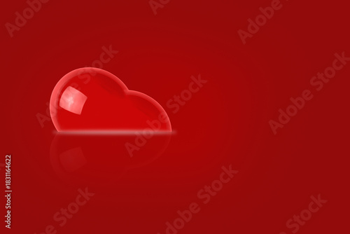 A voluminous glossy red heart on a uniform red background