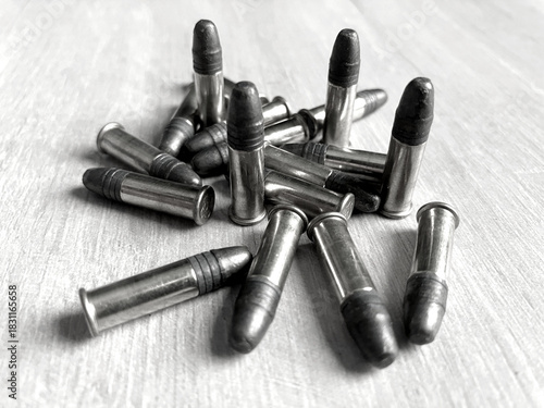 Pack of .22LR caliber bullets on wooden floor