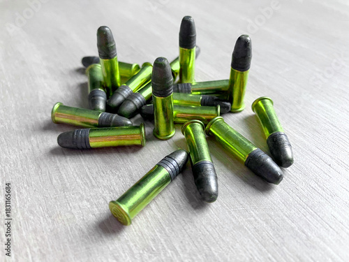 Pack of .22LR caliber bullets on wooden floor