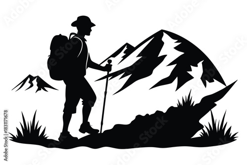 Silhouette of a hiker with backpack and stick is on mountain path towards peaks