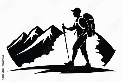 Silhouette of a hiker with backpack and trekking pole walks the mountain trail