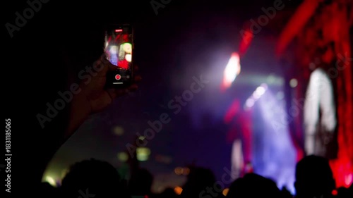 Person filming live music concert with smartphone