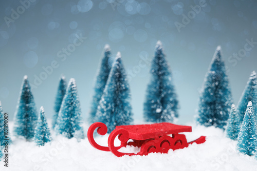 Festive holiday scene, Idyllic winter landscape displaying sled full of gifts surrounded by pine trees