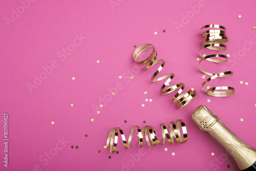 Champagne bottle with confetti stars on color background, space for text